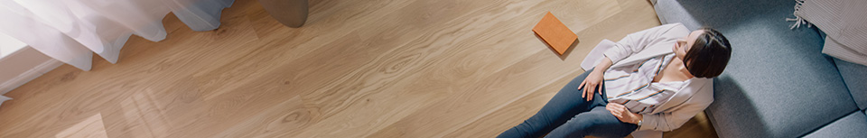 top view of person sitting on floor against a blue couch