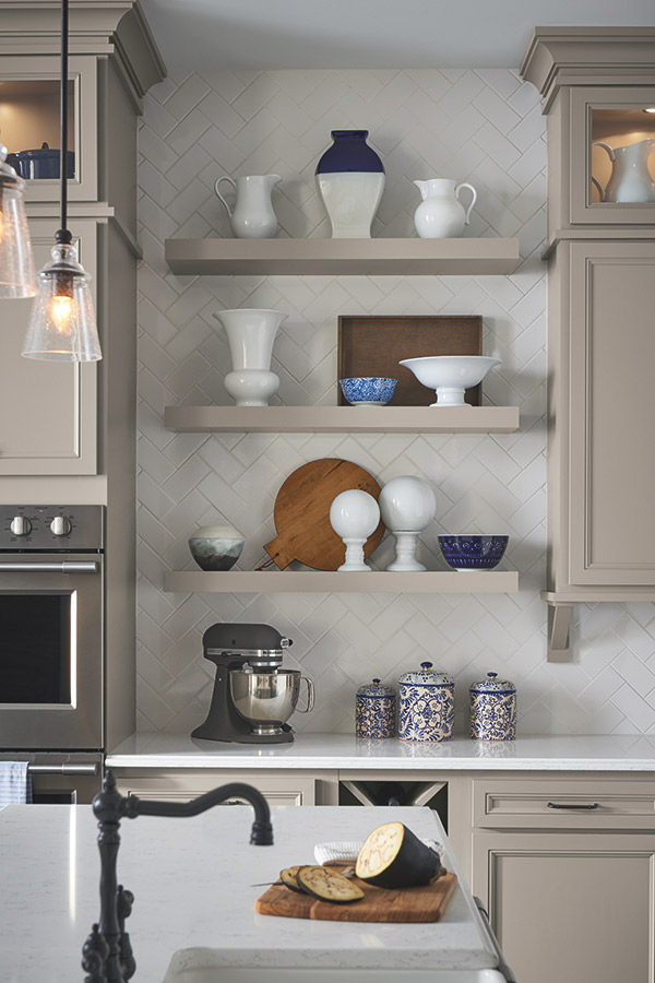 three floating shelves in stone grey with kitchen utensils on them