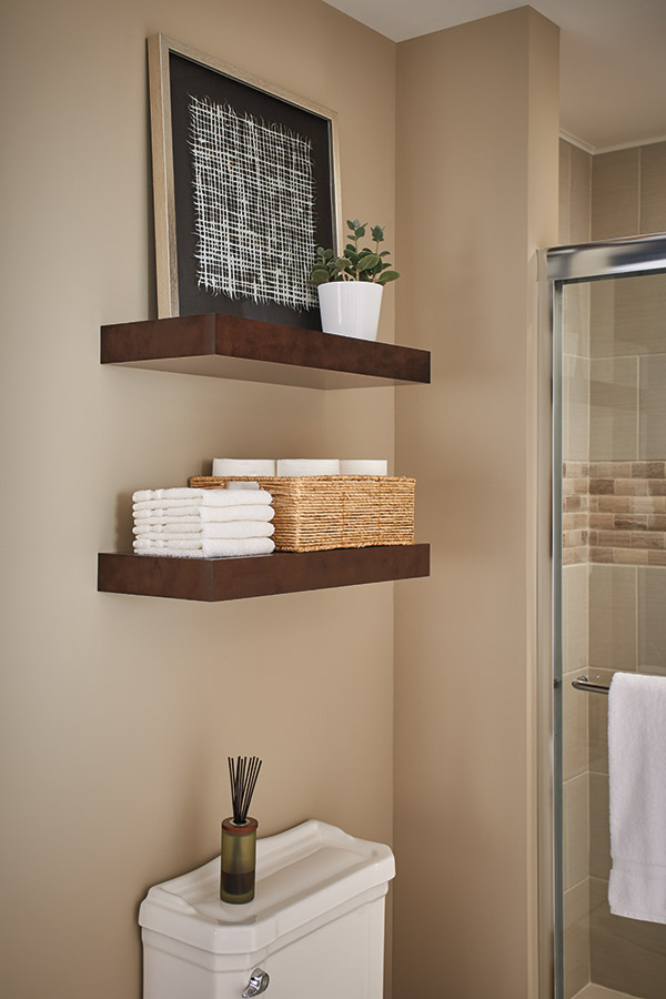 three floating shelves in stone grey with kitchen utensils on them